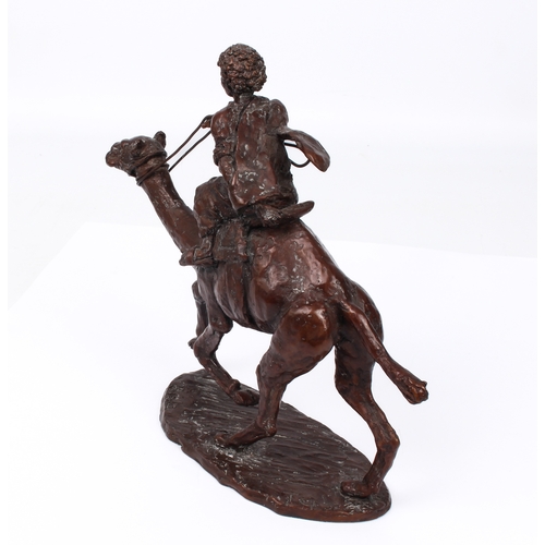 696 - A modern bronze figure of a camel rider - indistinctly signed, with red-brown patination, 23.5cm hig... 