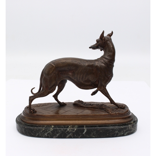 700 - after E. Delabrierre (1829-1912) - a bronze of a greyhound, 20th century, holding a riding crop in i... 