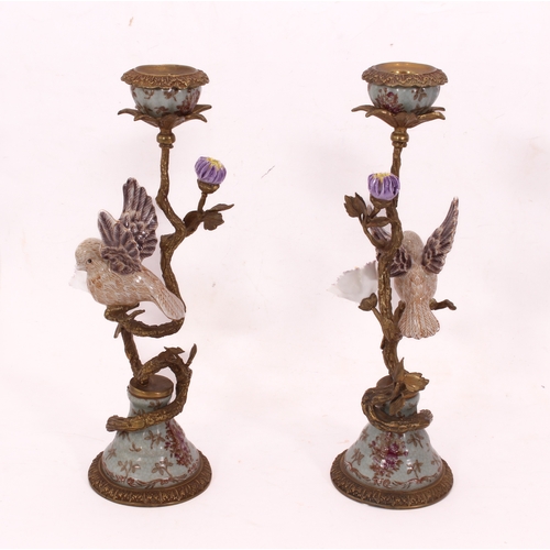 709 - A mirrored pair of Meissen style gilt metal and porcelain candlesticks - late 20th century, the lobe... 