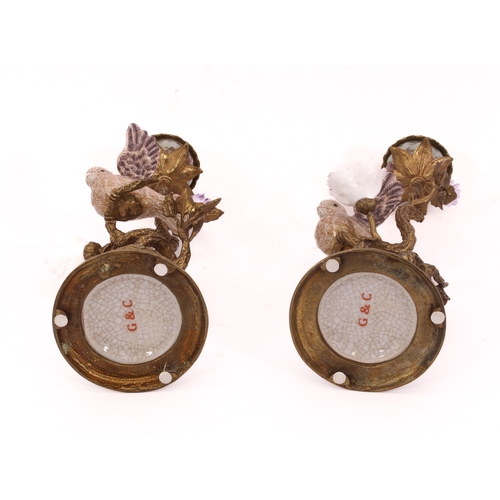 709 - A mirrored pair of Meissen style gilt metal and porcelain candlesticks - late 20th century, the lobe... 