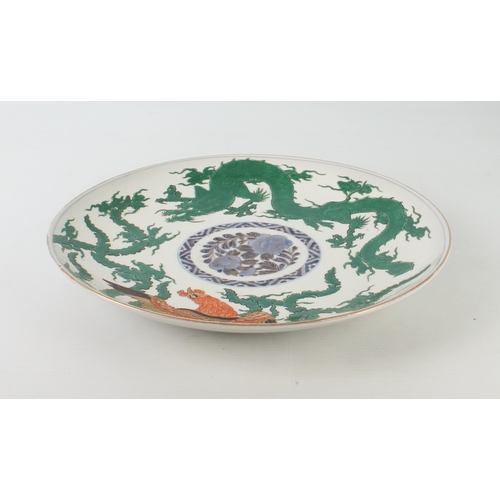 102 - A Japanese Arita porcelain dragon and phoenix saucer dish - made for the Chinese market, painted wit... 