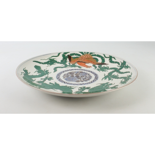 102 - A Japanese Arita porcelain dragon and phoenix saucer dish - made for the Chinese market, painted wit... 