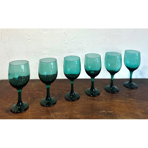 46 - A set of six green-glass wine glasses - probably 1960s-70s, with drawn ovoid bowls, plain stems and ... 