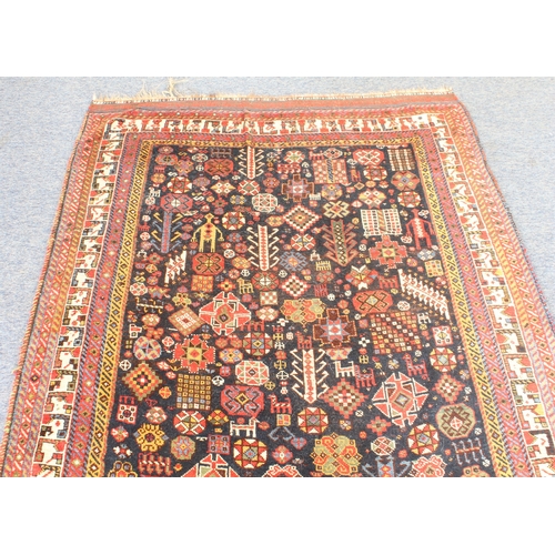 615 - A Qashqai rug - 19th century, the very deep blue ground with dense all over decoration with two huma... 