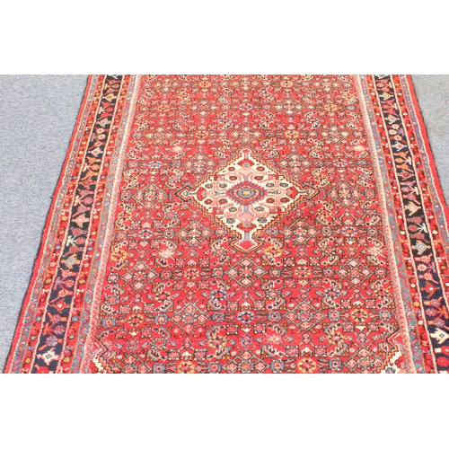 616 - A Hamadan rug, north west Persia - 20th century, red ground, central ivory medallion and spandrels a... 