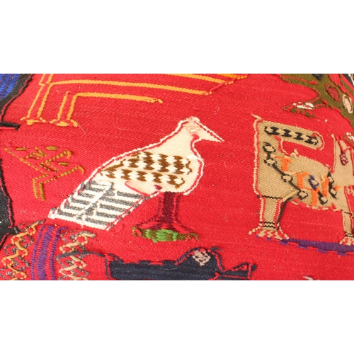 621 - A South African kilim rug or hanging, Ecuador - late 20th century, the red ground decorated with a v... 