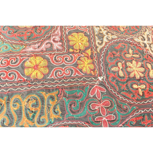 659 - A Lakai Uzbek silk embroidered panel - probably early 20th century, decorated with repeating roundel... 