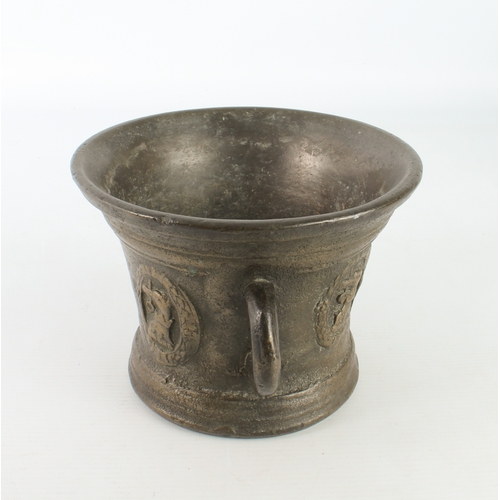 680 - A large cast bronze mortar, probably 19th century - with two loop handles, cast with armorials, 12.5... 