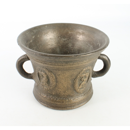 680 - A large cast bronze mortar, probably 19th century - with two loop handles, cast with armorials, 12.5... 