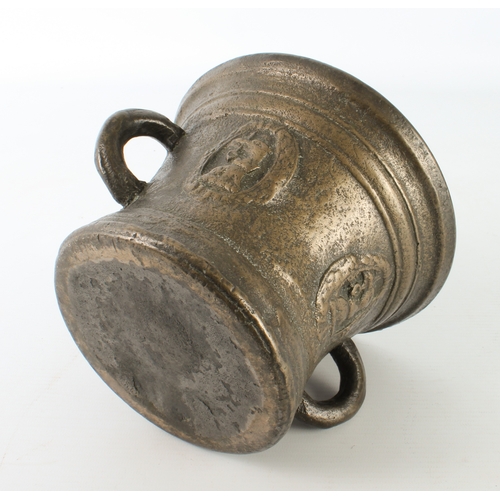 680 - A large cast bronze mortar, probably 19th century - with two loop handles, cast with armorials, 12.5... 