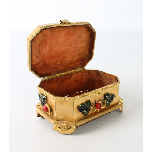 706 - An unusual gilt-metal jewellery box set with enamel cabochons, faded red silk interior and leather c... 