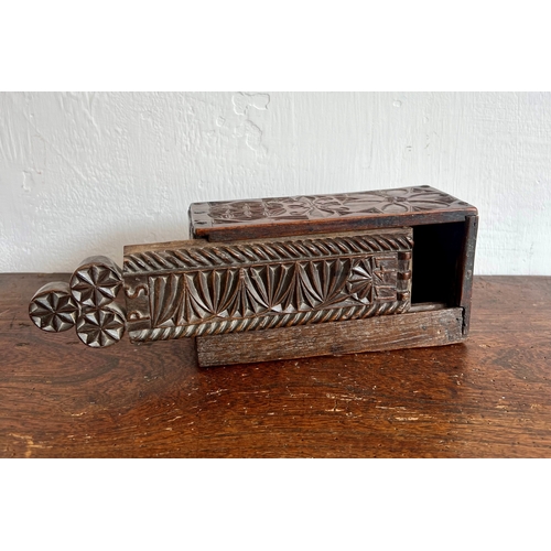 718 - A mid-18th century treen carved oak and beech candle box - of rectangular form and nailed constructi... 