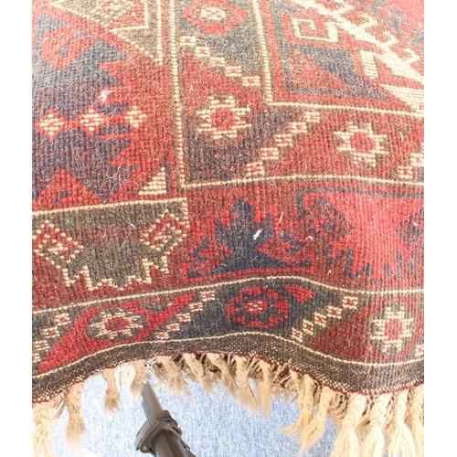 619 - A Turkish hand knotted Dosmealti rug - 20th century, the rose red ground with a central lozenge meda... 