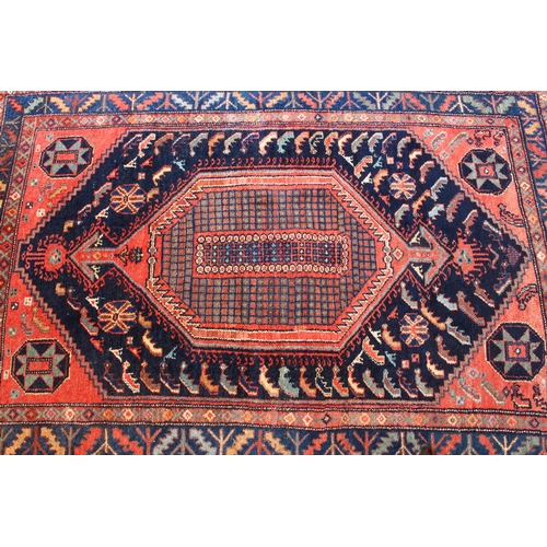 625 - A Kurdish hand knotted wool rug, Persian-Kurdistan - c.1900, the large central chequerboard lozenge ... 