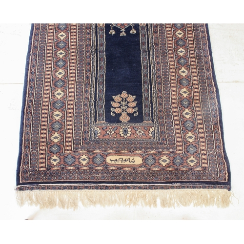 626 - A Pakistan prayer rug - late 20th century, with dark blue central Mihrab with hanging lamp, within a... 