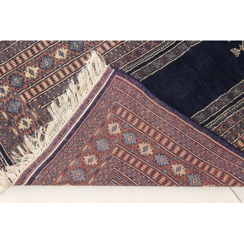 626 - A Pakistan prayer rug - late 20th century, with dark blue central Mihrab with hanging lamp, within a... 