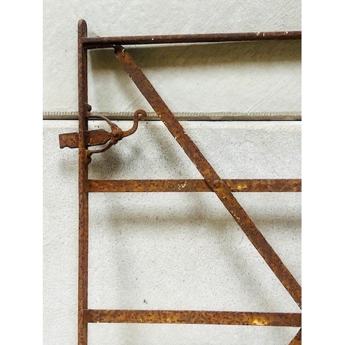 588 - A wrought iron gate - upright rectangular form with six rails and cross stretchers, with latch, 116c... 