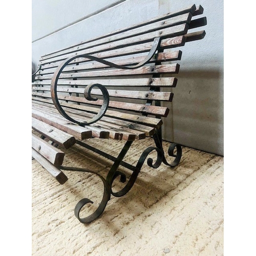 590 - A Victorian style wrought iron park or garden bench - with scroll arms, slatted seat and three scrol... 