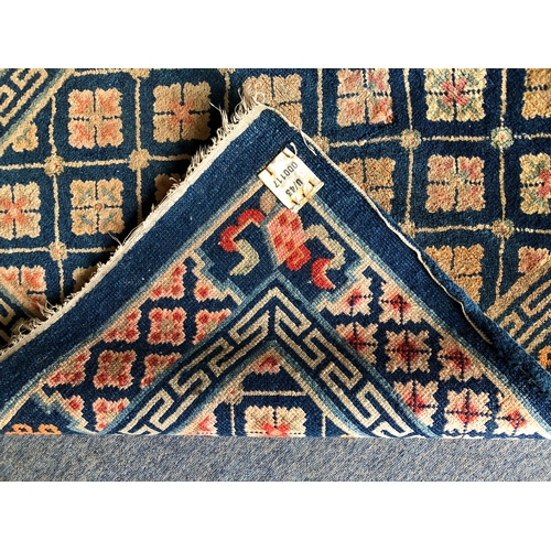 605 - A small Chinese wool rug - mid-20th century, with all over floral decoration on a blue ground, withi... 