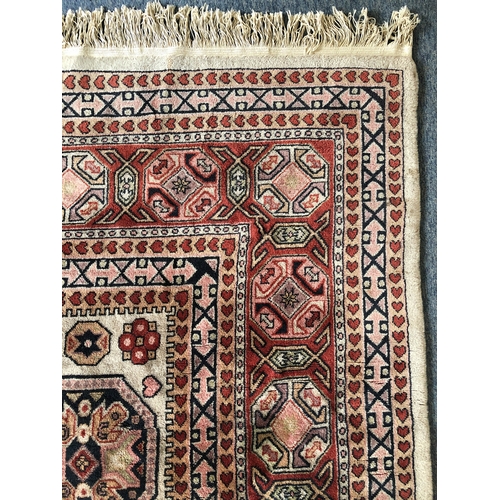 607 - A large Turkish wool rug - mid-2th century, the large, madder lozenge medallion with an inner buff o... 