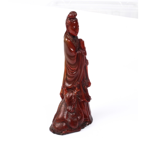 64 - A Chinese red-stained carved horn figure of Guanyin - Qing dynasty, probably 19th century, the figur... 