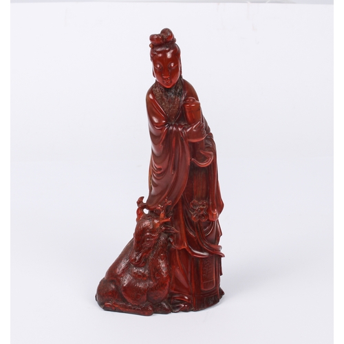 64 - A Chinese red-stained carved horn figure of Guanyin - Qing dynasty, probably 19th century, the figur... 