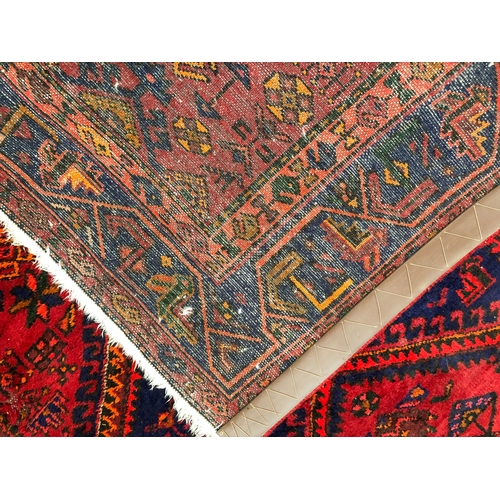 609 - A Hamadan hand-knotted wool rug - late 20th century, the dark-blue and red lozenge hooked pendant me... 