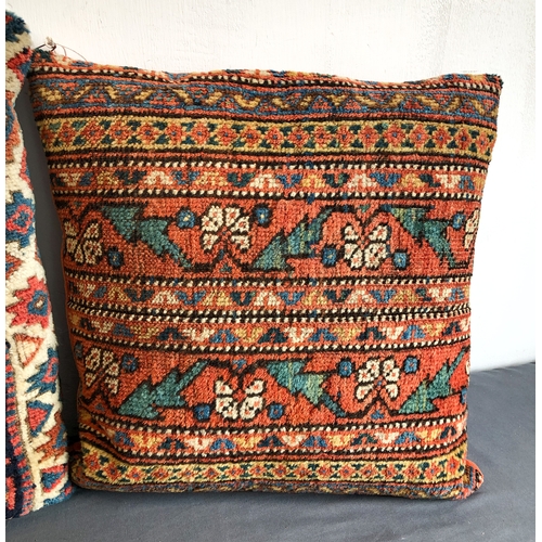 628 - Two North-West Persian rug fragment cushions - the larger 48 x 40cm, the other 38 x 38cm.