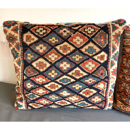 628 - Two North-West Persian rug fragment cushions - the larger 48 x 40cm, the other 38 x 38cm.