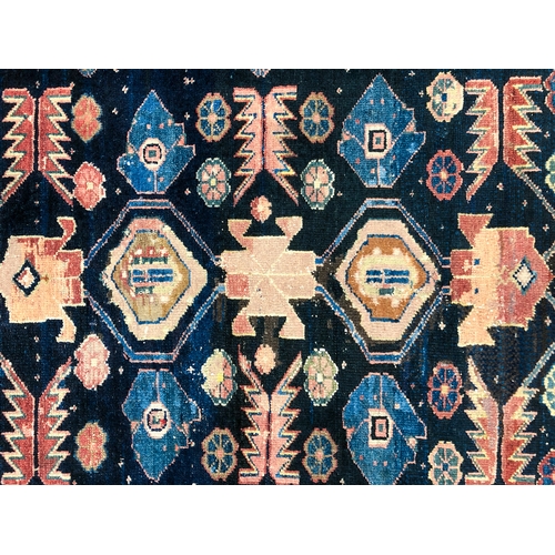 639 - An Armenian single wefted rug - c.1900, the deep blue ground with stylised lozenges and flower heads... 