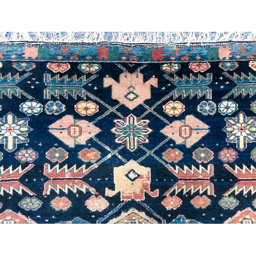 639 - An Armenian single wefted rug - c.1900, the deep blue ground with stylised lozenges and flower heads... 