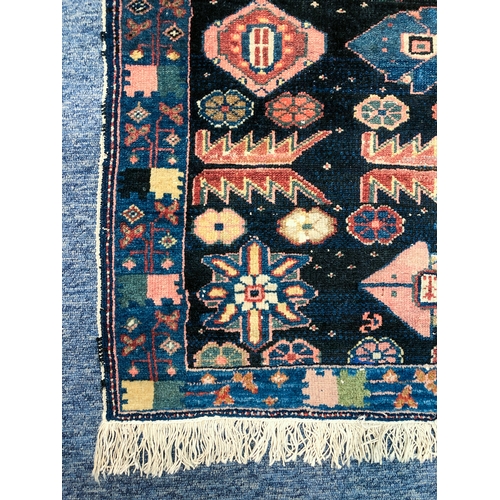 639 - An Armenian single wefted rug - c.1900, the deep blue ground with stylised lozenges and flower heads... 