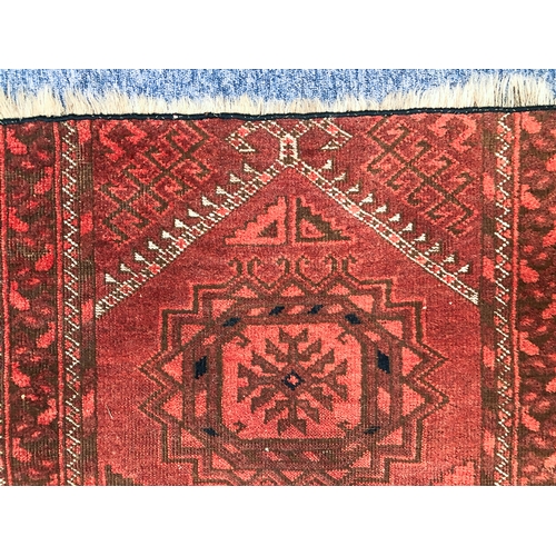 644 - A Turkoman prayer rug fragment - c.1900, the red ground with prayer mihrab and two gols, reduced in ... 