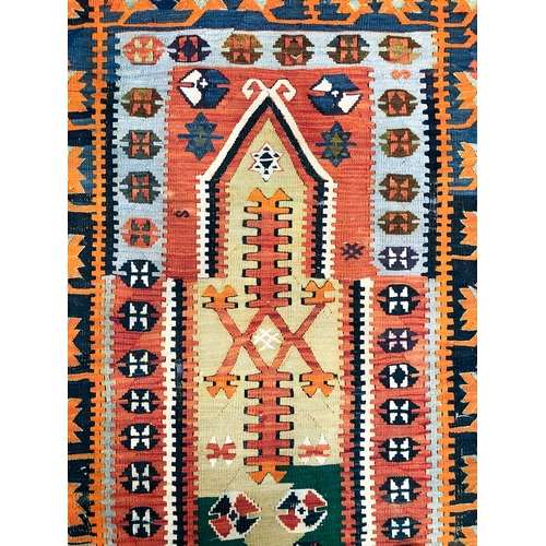 634 - A Turkish prayer kilim, early 20th century - the terracotta ground with a prayer mihrab in dark gree... 