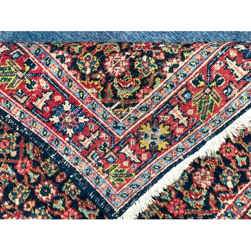 638 - A Heriz rug, north-west Persia - mid-20th century, the deep blue ground with all over Herati design,... 