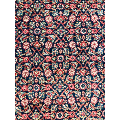 638 - A Heriz rug, north-west Persia - mid-20th century, the deep blue ground with all over Herati design,... 