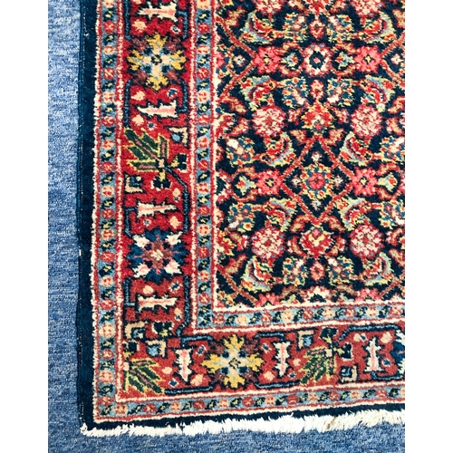 638 - A Heriz rug, north-west Persia - mid-20th century, the deep blue ground with all over Herati design,... 