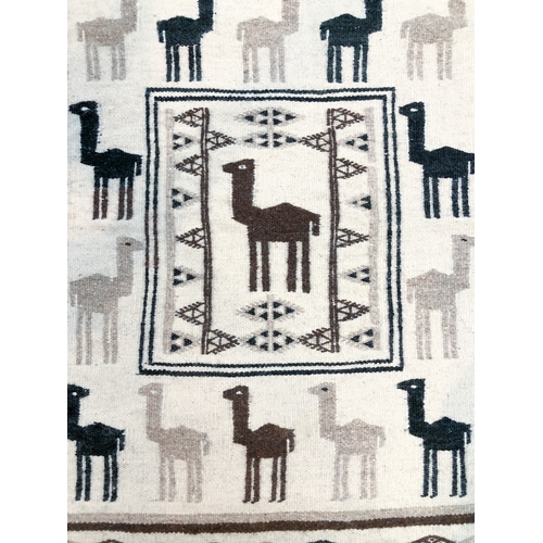 642 - An Ecuador flatweave rug - decorated in black and brown with llamas on an ivory ground, 109 x 81cm.