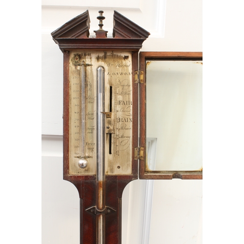 264 - A George III mahogany stick barometer by William Horrod of London - the broken architectural pedimen... 