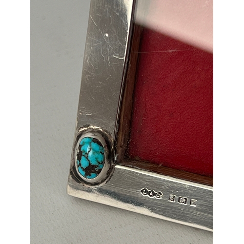 108 - A Liberty silver Arts & Crafts photograph frame set with two natural turquoise cabochon stones, oak ... 