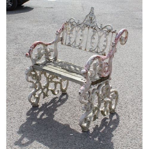 599 - A three piece painted cast metal garden furniture set in the Victorian style - comprising a table wi... 