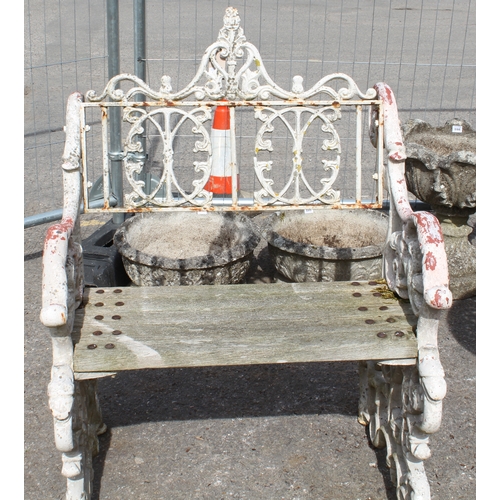 599 - A three piece painted cast metal garden furniture set in the Victorian style - comprising a table wi... 