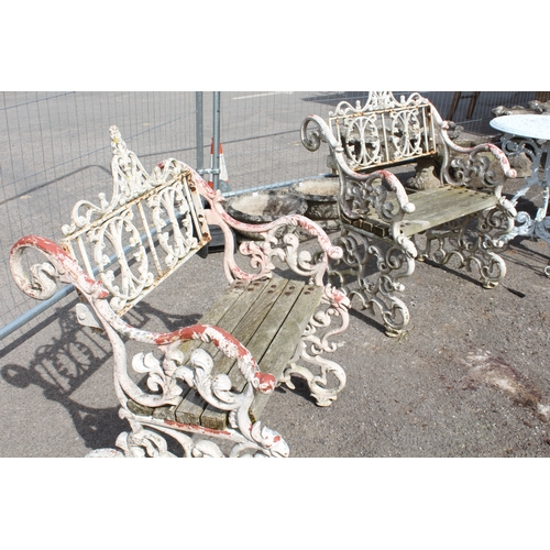 599 - A three piece painted cast metal garden furniture set in the Victorian style - comprising a table wi... 