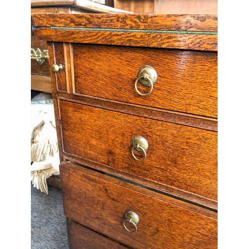 498 - A mid-18th century oak bachelor's chest - the rectangular fold-over top opening on lopers, lined wit... 