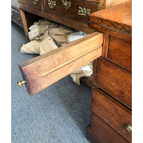 498 - A mid-18th century oak bachelor's chest - the rectangular fold-over top opening on lopers, lined wit... 