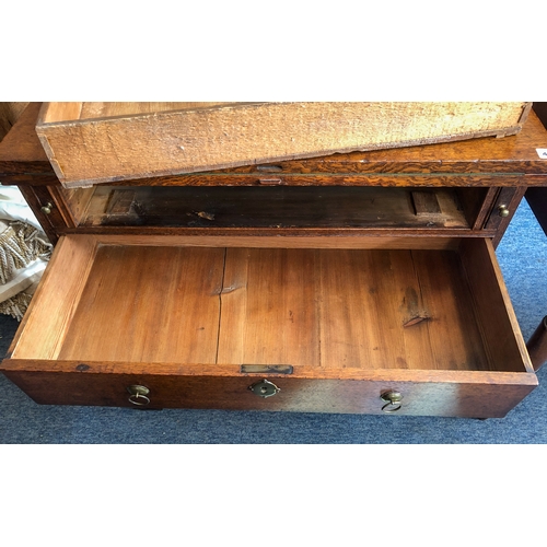 498 - A mid-18th century oak bachelor's chest - the rectangular fold-over top opening on lopers, lined wit... 