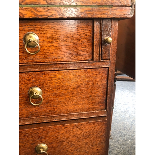 498 - A mid-18th century oak bachelor's chest - the rectangular fold-over top opening on lopers, lined wit... 