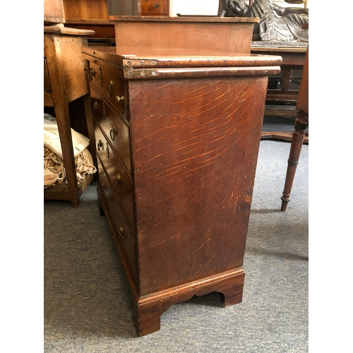 498 - A mid-18th century oak bachelor's chest - the rectangular fold-over top opening on lopers, lined wit... 