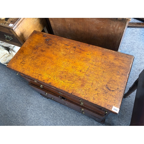 498 - A mid-18th century oak bachelor's chest - the rectangular fold-over top opening on lopers, lined wit... 