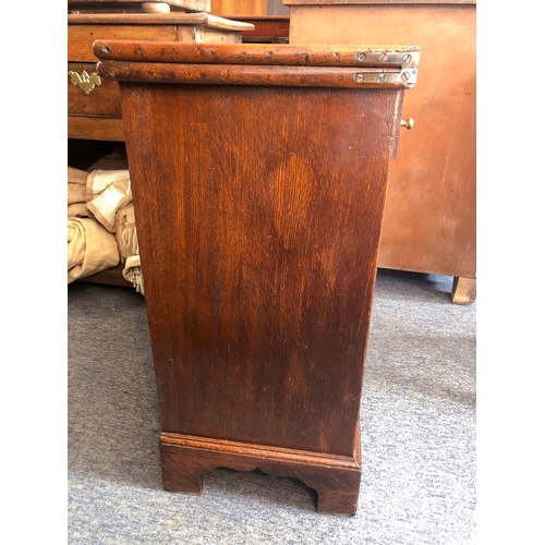 498 - A mid-18th century oak bachelor's chest - the rectangular fold-over top opening on lopers, lined wit... 